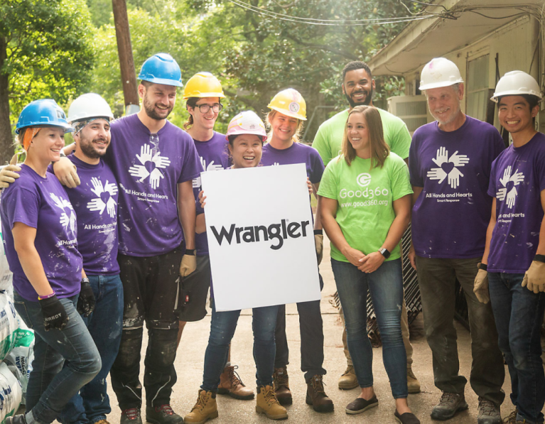 Volunteers holding a Wrangler sign